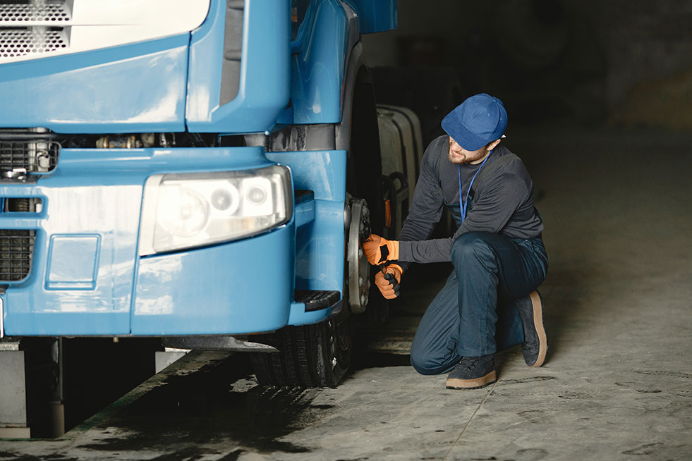 man checking truck tire